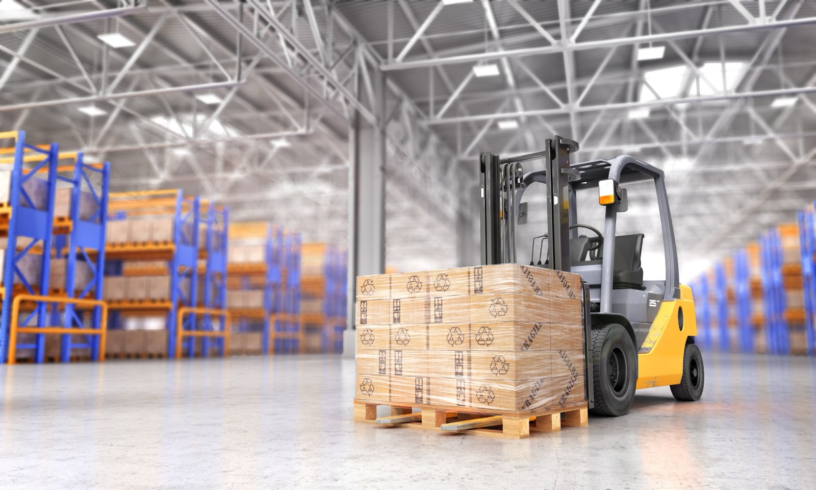 A yellow forklift carrying a wrapped pallet of boxes in a warehouse
